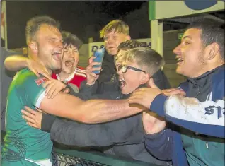  ?? Picture: Ian Scammell ?? Ashford’s Gary Lockyer celebrates their Isthmian South East play-off semifinal victory with the fans while Frannie Collin, left, and Tommie Fagg, right, battle for possession against Cray Valley