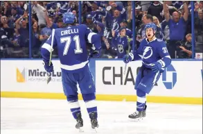  ?? Bruce Bennett / Getty Images ?? The Lightning’s Yanni Gourde , right, is congratula­ted by Anthony Cirelli after scoring a goal against the New York Islanders during the second period of Game 7 at Amalie Arena in Tampa, Fla., on Friday.