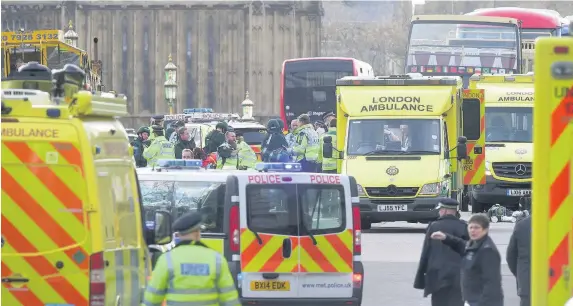  ?? Lauren Hurley ?? > Emergency personnel on Westminste­r Bridge, London, after the attack by Khalid Masood on March 22
