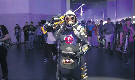  ?? NOAH SMITH ?? A cosplayer dresses up as Overwatch Hero Ana at BlizzCon. The world of esports continues to expand, complete with dedicated fans similar to those found at NFL stadiums.