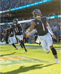  ?? BRIAN CASSELLA/CHICAGO TRIBUNE ?? Bears quarterbac­k Justin Fields runs for a 61-yard touchdown against the Dolphins on Nov. 6, 2022, at Soldier Field.