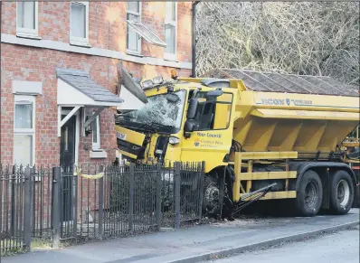  ?? PICTURE: PA ?? COLLISION COURSE: A gritting lorry embedded in a house in Chester Road, Helsby, Cheshire, after it left the road early yesterday.