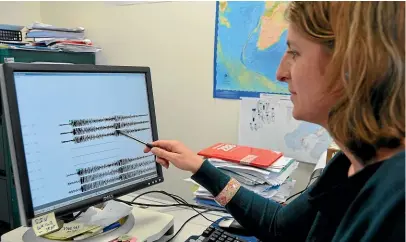  ??  ?? Dr Caroline Holden, of GNS Science, checks seismic recordings prior to calculatin­g the magnitude, depth and location of an aftershock during the 2011 quakes.