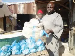  ??  ?? This trader earns a living from sale of baobab fruits