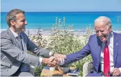  ??  ?? France’s Emmanuel Macron and Joe Biden in Cornwall yesterday. The US president linked the infrastruc­ture announceme­nt to confrontin­g China’s Belt and Road scheme