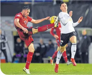  ??  ?? County’s Keith Watson is challenged by Lawrence Shankland