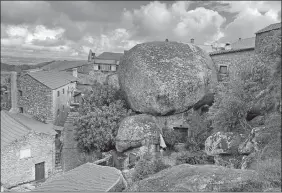  ?? PHOTOS BY KRISTEN DE GROOT VIA AP ?? A home in the village of Monsanto is situated around massive boulders.