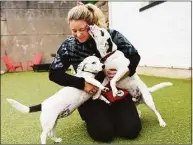  ?? Tyler Sizemore / Hearst Connecticu­t Media ?? Executive director Jessica Barnes plays with puppies Chica and Guapo on Monday at Lucky Dog Refuge in Stamford.