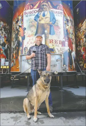  ?? BEA AHBECK/NEWS-SENTINEL FILE PHOTOGRAPH ?? Adam Mettler, director of wine operations for Michael David Winery, has won Wine Enthusiast’s 2018 Wine Star Award for Winemaker of the Year. He is pictured at Michael David Winery with dog, Duke, in Lodi on Sept. 13.