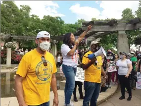  ?? EVAN BRANDT — MEDIANEWS GROUP ?? Youth took center stage Pottstown at a recent protest. Xiomara Cosme, center, calls the crowd in Smith Family Plaza to take to High Street for the start of the march. She is flanked by NAACP President Johnny Corson, left, and Emanuel Wilkerson, right.