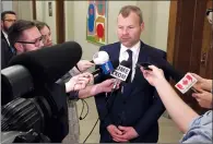  ?? CP FILE PHOTO ?? Saskatchew­an Energy Minister Dustin Duncan scrums with reporters at the provincial legislatur­e in Regina.