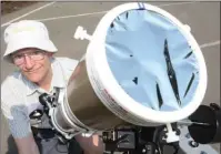  ?? GARY NYLANDER/The Okanagan Weekend ?? Hugh Pett is seen with with his 3 1/2 inch refractor telescope fitted with a special solar filter that allows safe viewing of the sun, cutting the its intensity down by 10,000 times. Pett, a member of the Royal Astronomic­al Society of Canada, along...