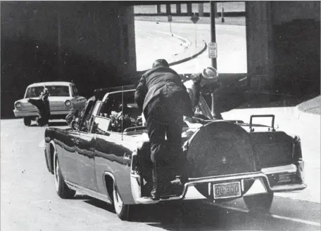  ?? James “Ike” Altgens Associated Press ?? JACQUELINE KENNEDY and a Secret Service agent try in vain to help after President Kennedy’s fatal shooting Nov. 22, 1963, in Dallas.