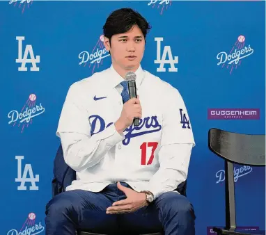  ?? Ashley Landis/Associated Press ?? The Dodgers’ Shohei Ohtani answers questions during a news conference at Dodger Stadium on Thursday.