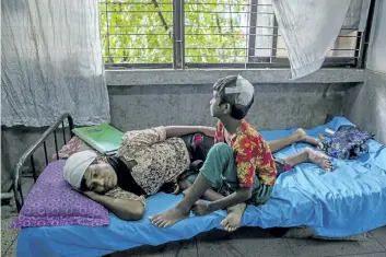  ?? DAR YASIN/THE ASSOCIATED PRESS ?? Rohingya woman Dildar Begum and her daughter Noor Kalima, who crossed over to Bangladesh recover at Sadar Hospital in Cox’s Bazar, Bangladesh, on Wednesday. Begum said she and her daughter, Noor Kalima, got stabbed by Myanmar soldiers and her husband...