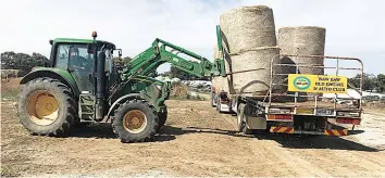  ?? ?? Members of Baw Baw Old Engine and Auto Club and the Trafalgar Truck Restorers Club co-ordinated a hay drive for Rochester farmers.