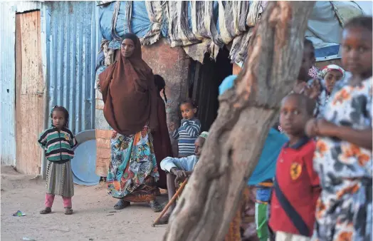  ?? JOE GIDDENS, AP ?? Women and children crowd a displacedp­ersons camp in Hargeisa, Somalia.