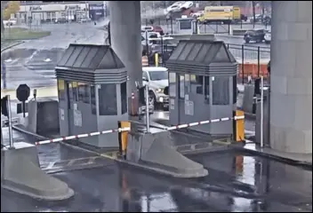  ?? ASSOCIATED PRESS ?? In this image taken from security video, a light-colored vehicle (top center) flies over a fence into the Rainbow Bridge customs plaza Wednesday in Niagara Falls, NY. The vehicle exploded on the American side of the US-Canada bridge, leaving two people dead.