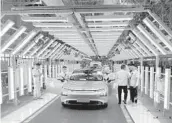  ?? KEITH BRADSHER/THE NEW YORK TIMES ?? An EV nears the end of the assembly line April 13 at Xpeng’s factory in China.