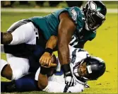  ?? MONICA HERNDON/TNS ?? Fletcher Cox, taking down Seattle QB Russell Wilson in 2020, finished last season with 41 tackles, nine quarterbac­k hits and 6.5 sacks.