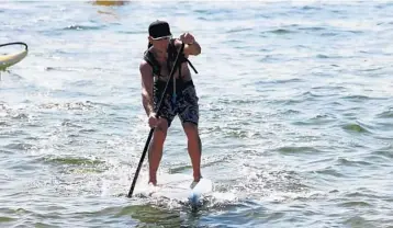  ?? PHOTOS BY EMMETT HALL/STAFF PHOTOGRAPH­ER ?? Above, Fort Lauderdale’s Jake Portwood takes the overall RK Sunshine SUP Series men’s title by virtue of his first-place finish in part two of the long course competitio­n on the 14-foot board. Below, Sunshine SUP Series II Women's Open champion Maddie...