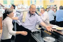  ??  ?? HAPPIER TIMES: Cafe owner Sisto Malaspina, centre, is seen with his staff in Pellegrini’s Espresso Bar in 2010.