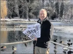  ??  ?? Bosworth In Bloom treasurer Brian Cox shows off some of the first-ever Bosworth In Bloom calendars produced for 2018, at a picturesqu­ely frozen Market Bosworth Country Park