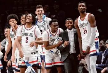  ?? Mary Altaffer/associated Press ?? Uconn’s Tristen Newton (2) and his teammates celebrate in the final seconds of a second-round NCAA Tournament win against Northweste­rn on Sunday in New York. Now the Huskies face the team they beat for last year’s title.