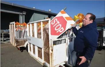  ?? PHOTOS BY SHERRY LAVARS — SPECIAL TO MARIN INDEPENDEN­T JOURNAL ?? San Rafael public works operations manager Mark Wright looks over the many devices used for roadways during power outages. A planned shutoff for much of Marin was called off Tuesday afternoon.