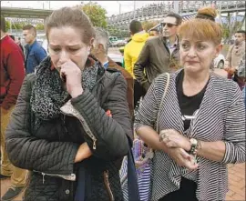  ?? Mauricio Duenas Castaneda EPA/Shuttersto­ck ?? RELATIVES WAIT for informatio­n about victims at the scene of the bombing in Bogota, Colombia. A truck detonated with 180 pounds of explosives, officials said.