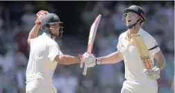  ??  ?? DOUBLE DELIGHT: Shaun Marsh, right, celebrates scoring a century against England as he runs past his brother Mitchell at the SCG yesterday.