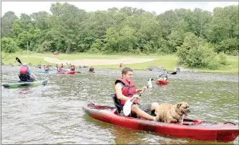  ?? Keith Bryant/The Weekly Vista ?? Bella Vista resident Aaron Pavlak and his pug-terrier mix AJ test ride a sitdown kayak together. The dog was nervous at first, Pavlak said, but he didn’t take long to relax and enjoy the ride. “He’s just an adventure dog,” Pavlak said. “He likes to go...