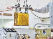  ?? REUTERS ?? Technician­s lower MOXIE instrument into the belly of the Perseveran­ce rover at a Nasa lab in Pasadena, California