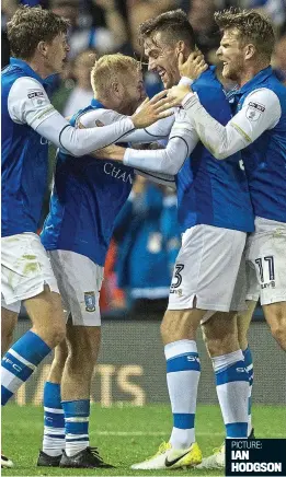  ??  ?? Wonder goal: David Jones is mobbed by his Wednesday team-mates after his second-half stunner earned a point