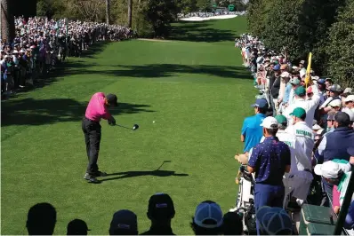  ?? The Associated Press ?? ■ Tiger Woods tees off on the 18th hole during the first round at the Masters Thursday in Augusta, Ga.