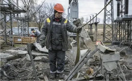  ?? ED RAM/GETTY ?? A worker repairs infrastruc­ture Friday at a power station in Kyiv, Ukraine, that was damaged in a Russian attack.