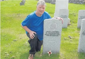  ??  ?? Patrick Anderson at the Kircudbrig­ht grave of Arbroath soldier Corporal Charles Edward Withington, right.