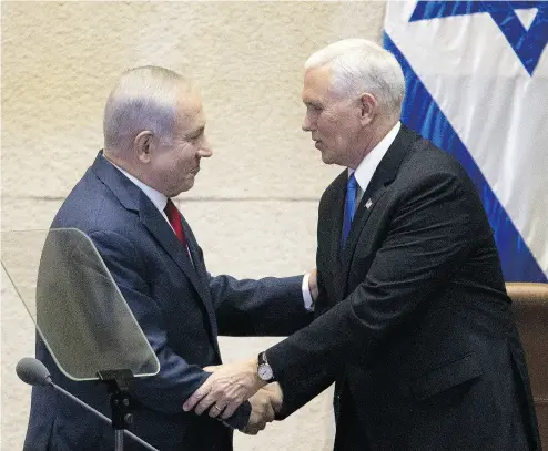  ?? ARIEL SCHALIT / AFP / GETTY IMAGES ?? U. S. Vice President Mike Pence, right, shakes hands with Israeli Prime Minister Benjamin Netanyahu at the Knesset in Jerusalem on Monday. The visit is the final leg of a trip that has included talks in Egypt and Jordan.