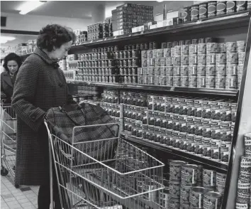  ?? ?? Stock answers A shopper browses the newly opened Sainsbury’s supermarke­t in SuttonJ 1970