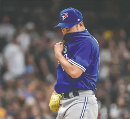  ?? USA TODAY SPORTS ?? Toronto Blue Jays pitcher Yusei Kikuchi reacts between batters in the second inning during a game against the Milwaukee Brewers Saturday. He was pulled from the mound shortly thereafter. Kikuchi, 2-4 with a 5.08 ERA, has yet to go past five innings in five starts this month.