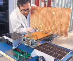  ?? SOURCE: NASA/JPL-CALTECH ?? Engineer Joel Steinkraus uses sunlight to test the solar arrays on one of the Mars Cube One (MarCO) spacecraft at NASA’s Jet Propulsion Laboratory in Pasadena, Calif., in March.
