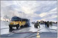  ?? (Special to the Arkansas Democrat-Gazette/John Bailey) ?? First-responders handle a school bus fire Wednesday after a car rear-ended the bus while it was stopped picking up children near Green Forest. The driver of the car died in the accident. No one on the bus suffered injuries.