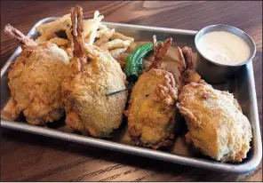  ?? Arkansas Democrat-Gazette/JENNIFER CHRISTMAN ?? Saltgrass Steak House’s signature Range Rattlers appetizer consists of fried bundles of jalapenos, shrimp and jack cheese served with fried onions and ranch.