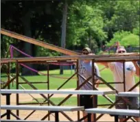  ?? MARIAN DENNIS — DIGITAL FIRST MEDIA ?? Volunteers help set up on Thursday for the upcoming Pottstown Rumble.