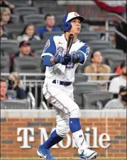  ?? HYOSUB SHIN/HYOSUB.SHIN@AJC.COM ?? Ehire Adrianza hits three-run homer Friday, the third pinch-hit home run the Braves have hit in just seven games this season.