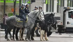  ?? Darrell Sapp/Post-Gazette ?? Four members of the Pittsburgh Bureau of Police Mounted Patrol Unit wait Tuesday on a closed section of Grant Street in front of the City-County Building.