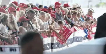  ?? Joe Raedle Getty Images ?? SUPPORTERS WAIT for President Trump to arrive at an Orlando-Melbourne airport hangar in Florida for a rally. “I ... want to speak to you without the filter of the fake news,” he later told the enthusiast­ic crowd.