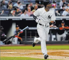  ?? Julie Jacobson ?? The Associated Press Yankees rookie Miguel Andujar tosses aside his bat Friday after hitting a fourthinni­ng home run, the first of four homers by New York in its 8-1 win over the Red Sox.
