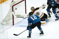  ?? (Reuters) ?? SAN JOSE SHARKS forward Patrick Marleau (left) scores a secondperi­od goal past Boston Bruins netminder Tuukka Rask during a game the Bruins ended up winning 2-1 in overtime on the road on Sunday night in NHL action.