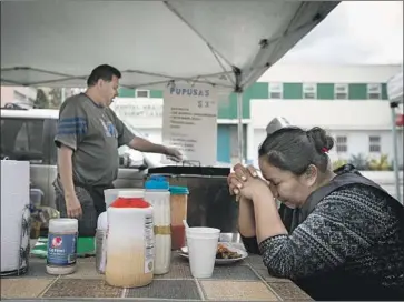  ?? Francine Orr Los Angeles Times ?? PATRICIA MONTOYA prays as her husband, Manuel, prepares pupusas at their food stand Tuesday. The City Council considered proposals to set up loans and grants for L.A. businesses affected by the pandemic.